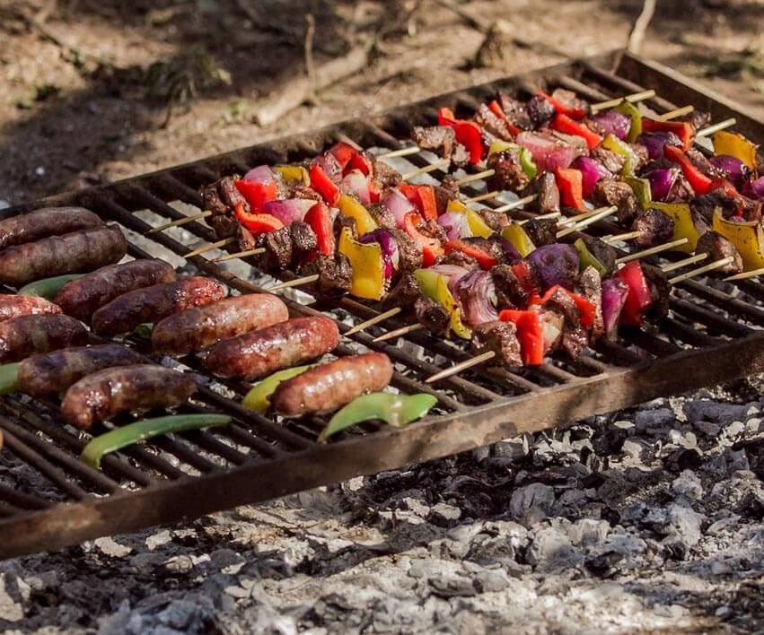 Traditional Argentine asado parrilla — H&H Outfitters hunt lunch